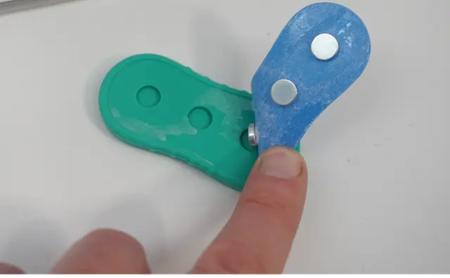 Sold on Amazon by BUSOHA: Recalled BUSOHA Magnetic Fidget Slider Toy with silicone casing removed, exposing magnets, photo 3 of 3