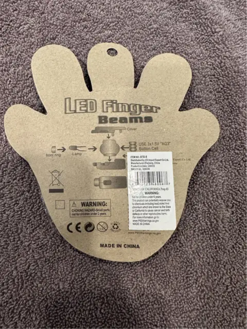 ZMC Group Recalls LED Finger Beam Lights Due to Risk of Serious Injury or Death from Battery Ingestion; Violates Mandatory Standard for Toys: Recalled LED Finger Beam Lights (back of the package), photo 2 of 2